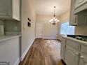 Kitchen and dining area with hardwood floors and white cabinets at 275 Allie Dr, Mcdonough, GA 30252