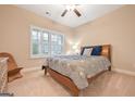 Bedroom with a queen bed, window with shutters, and carpeted floor at 240 Grand Oak Way, Sharpsburg, GA 30277