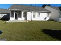 Back exterior view of home with screened porch and patio at 440 Falling Leaf Ct, Mcdonough, GA 30253