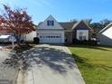Ranch style home with brick and vinyl siding, two-car garage, and landscaped yard at 440 Falling Leaf Ct, Mcdonough, GA 30253