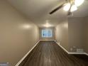 Spacious living room with dark wood floors and neutral walls at 4310 Bakers Ferry Sw Rd, Atlanta, GA 30331