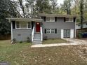 Newly renovated ranch home with gray exterior and attached garage at 4310 Bakers Ferry Sw Rd, Atlanta, GA 30331
