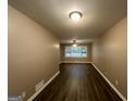 Spacious living room with dark wood floors and neutral walls at 4310 Bakers Ferry Sw Rd, Atlanta, GA 30331