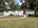 Newly renovated white brick ranch with red door and landscaping at 3168 Mcafee Rd, Decatur, GA 30032