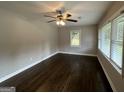 Living room with hardwood floors, neutral walls, and large windows at 3168 Mcafee Rd, Decatur, GA 30032