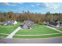 Aerial view of a house and surrounding neighborhood, showcasing a large lot and green space at 92 Gordon Oaks Way, Moreland, GA 30259