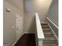 Staircase and entry door with dark hardwood floors at 208 Rankin Cir, Mcdonough, GA 30253