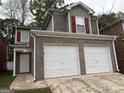 Brick two-story house with a two-car garage and red shutters at 208 Rankin Cir, Mcdonough, GA 30253