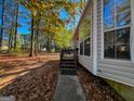 House side with steps and wooded area at 185 Anna Ave, Palmetto, GA 30268