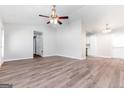 Open living room and dining area with hardwood floors and ceiling fan at 138 Michelle Dr, Mcdonough, GA 30252