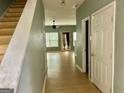 Light and bright entryway with stairs leading upstairs and view to living room at 150 Brookview Dr, Riverdale, GA 30274