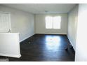 Bright living room featuring dark laminate floors and ample natural light at 12101 Fairington Ridge Cir, Lithonia, GA 30038