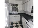 White kitchen with black countertops at 3290 Abbeywood Dr, Decatur, GA 30034