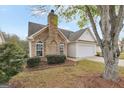 House exterior with stone accents and a two-car garage at 1120 Strath Clyde Way, Mcdonough, GA 30253