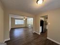 Bright dining room with vinyl flooring and kitchen access at 6410 Buckhurst Trl, Atlanta, GA 30349