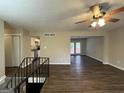 Open living room with vinyl flooring and access to kitchen and back patio at 6410 Buckhurst Trl, Atlanta, GA 30349