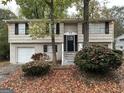 Two-story home with attached garage and landscaping at 6410 Buckhurst Trl, Atlanta, GA 30349