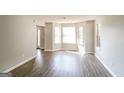 Spacious living room with bay windows and light-colored wood flooring at 2124 Hairston Creek Pkwy, Decatur, GA 30035