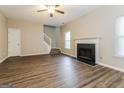 Spacious living room with fireplace and stairs at 7546 Petal Pl, Fairburn, GA 30213