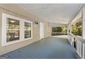 A spacious covered porch with light grey flooring and white railings at 465 Haynie Rd, Moreland, GA 30259