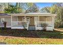 House exterior featuring a covered porch with white railings and steps at 465 Haynie Rd, Moreland, GA 30259