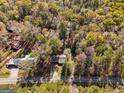 Aerial view of a house on a wooded lot with a long driveway at 465 Haynie Rd, Moreland, GA 30259