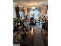 Formal dining room featuring a large table and hutch at 6722 Bent Creek Dr, Rex, GA 30273