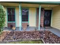 Inviting front porch with brick columns and entrance at 6722 Bent Creek Dr, Rex, GA 30273