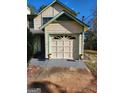 Attached garage with overhead door and ample space for parking and storage at 6722 Bent Creek Dr, Rex, GA 30273