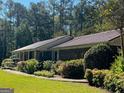 Ranch home with metal roof and mature landscaping at 1500 Pine Forest Rd, Mansfield, GA 30055