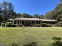 Brick ranch home with a long front porch at 1500 Pine Forest Rd, Mansfield, GA 30055