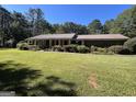 Brick ranch home with large yard and mature trees at 1500 Pine Forest Rd, Mansfield, GA 30055