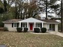 Brick ranch home with red door and carport at 4433 Mercer Rd, Decatur, GA 30035