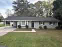 House exterior showcasing a gray brick facade and landscaping at 3691 Fred Walker Sw Dr, Smyrna, GA 30082