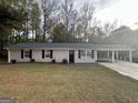 Charming ranch home with carport, situated on a grassy lot at 2997 Tara Woods Dr, Douglasville, GA 30135