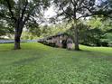 Brick house on a grassy lot with large trees and a swing set at 9267 Westview Sw Dr, Covington, GA 30014