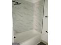 Bathroom with marble shower surround and tile floor at 1511 Mims Sw St, Atlanta, GA 30314