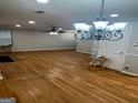 Open living room with hardwood floors and a chandelier at 1004 Alford Ct, Lithonia, GA 30058
