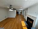Spacious living room with hardwood floors, fireplace and access to the kitchen at 1004 Alford Ct, Lithonia, GA 30058