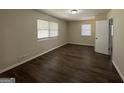 Spacious bedroom with dark brown laminate flooring and neutral walls at 2138 Springdale Rd, Atlanta, GA 30315