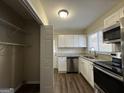 Galley kitchen with white cabinets, granite counters, and stainless steel appliances at 2233 Springdale Sw Cir, Atlanta, GA 30315