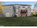 Two-story brick house with a deck and a large backyard at 2202 Escalade Ct, Conyers, GA 30094