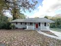 Gray ranch home with red door and landscaping at 2370 Tiffany Cir, Decatur, GA 30035