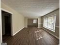 Spacious living room with hardwood floors and large windows at 2413 Ben Hill Rd, East Point, GA 30344