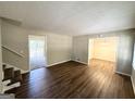 Living room with hardwood floors, access to a back deck, and a view of the dining area at 685 Sheppard Rd, Stone Mountain, GA 30083