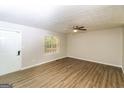Spacious living room with wood-look floors and ceiling fan at 215 Shadow Wood Dr, Douglasville, GA 30134