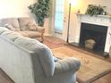 Living room with neutral colored couch, fireplace and hardwood floors at 6390 Arbor Ln, Morrow, GA 30260