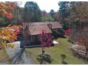 House with a metal roof and driveway, surrounded by trees at 2021 Brook Valley Ct, Jonesboro, GA 30236