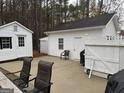 Backyard with detached storage buildings and a white picket fence at 116 Winthrop Dr, Sharpsburg, GA 30277