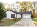 Recently painted white ranch home with a two-car garage and mature trees at 175 Jennifer Ln, Carrollton, GA 30116